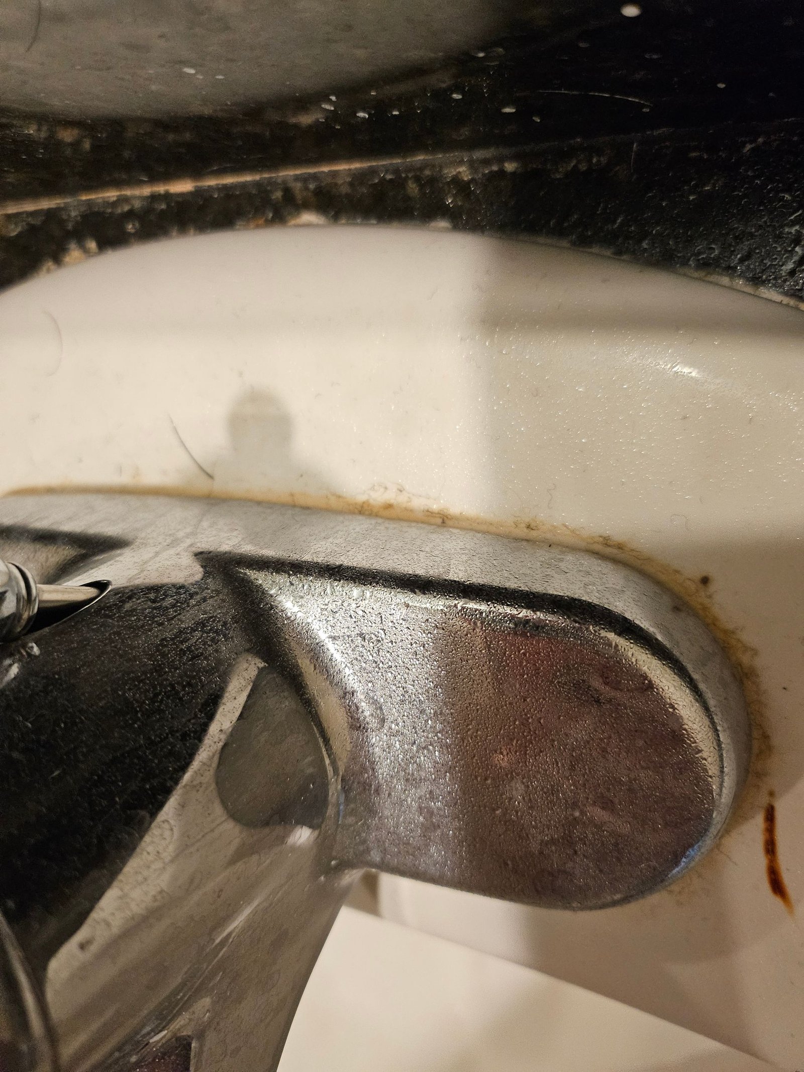 A close up of a faucet on a bathroom sink.