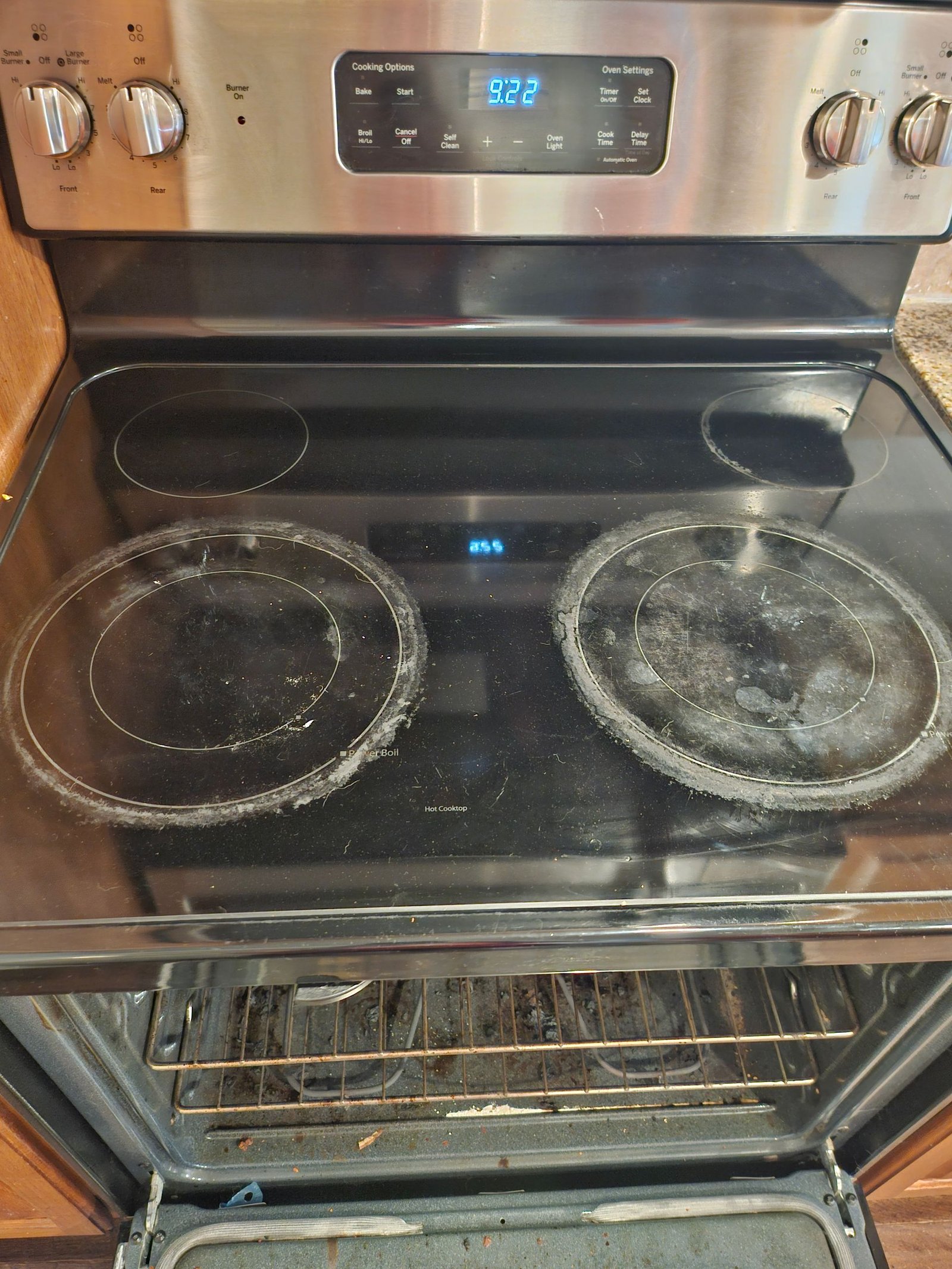 A stainless steel stove with two burners and an oven.