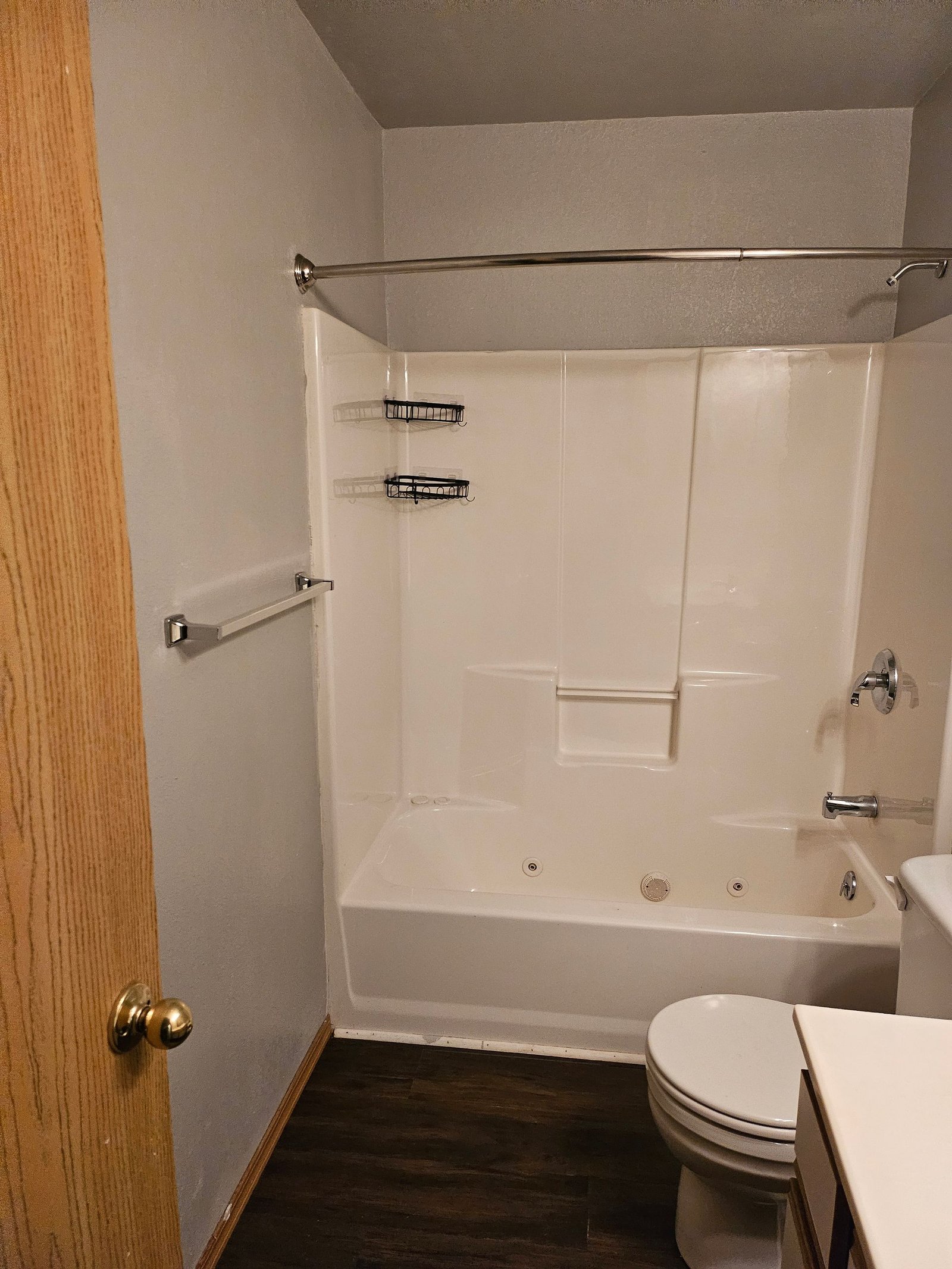 A bathroom with a tub, toilet and sink