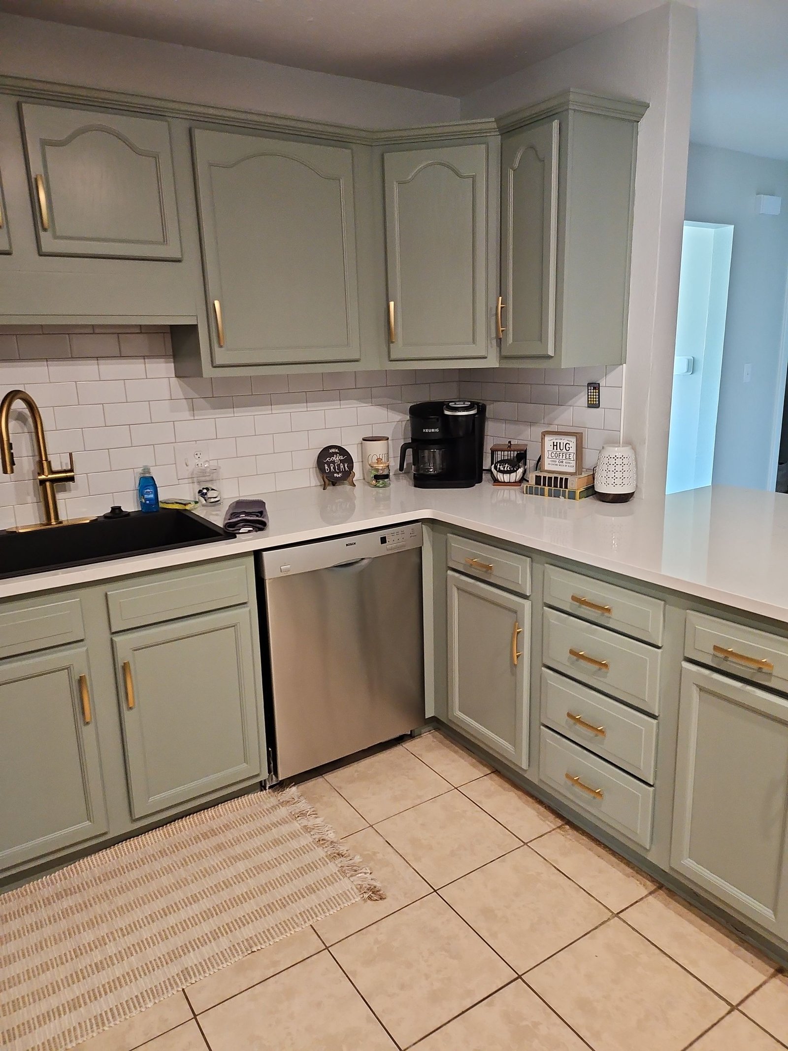 Clean kitchen with green cabinets