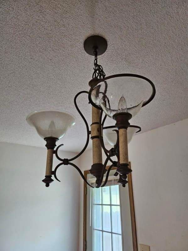 A chandelier is hanging from the ceiling in a room.